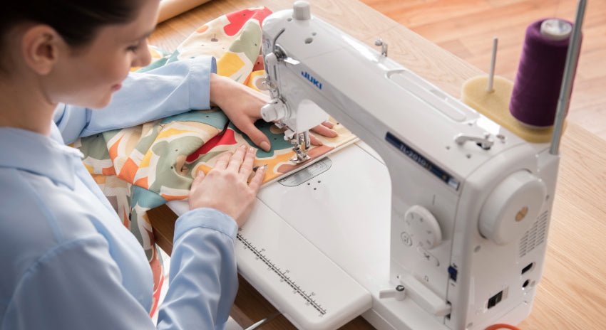 woman sewing fabric on a Juki 2010Q home sewing machine