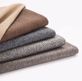 Stack of folded textured fabric swatches in various shades of brown and gray on a white background