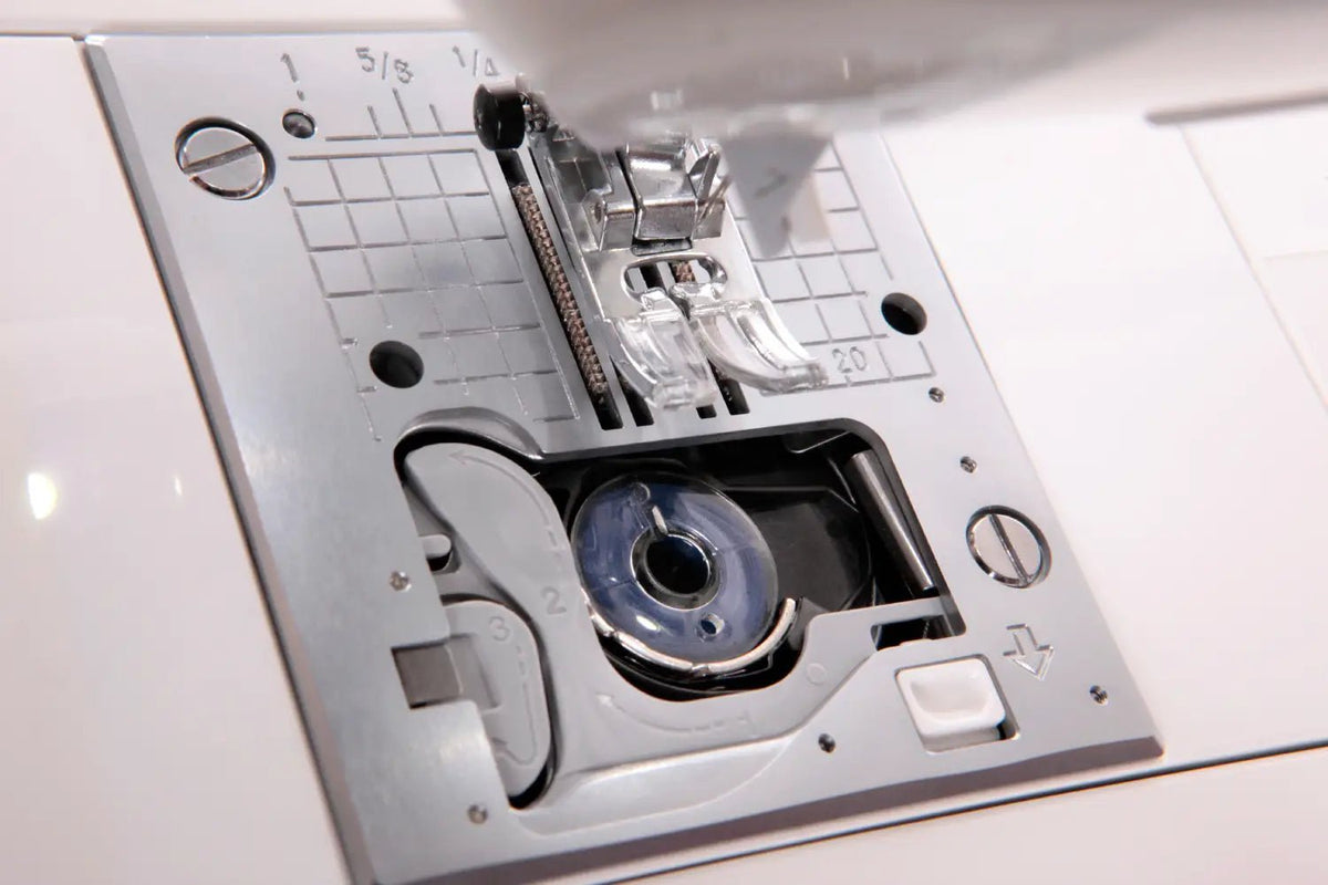 Close-up of a Jukis Exceed -HZL-F300 needle plate with various components.