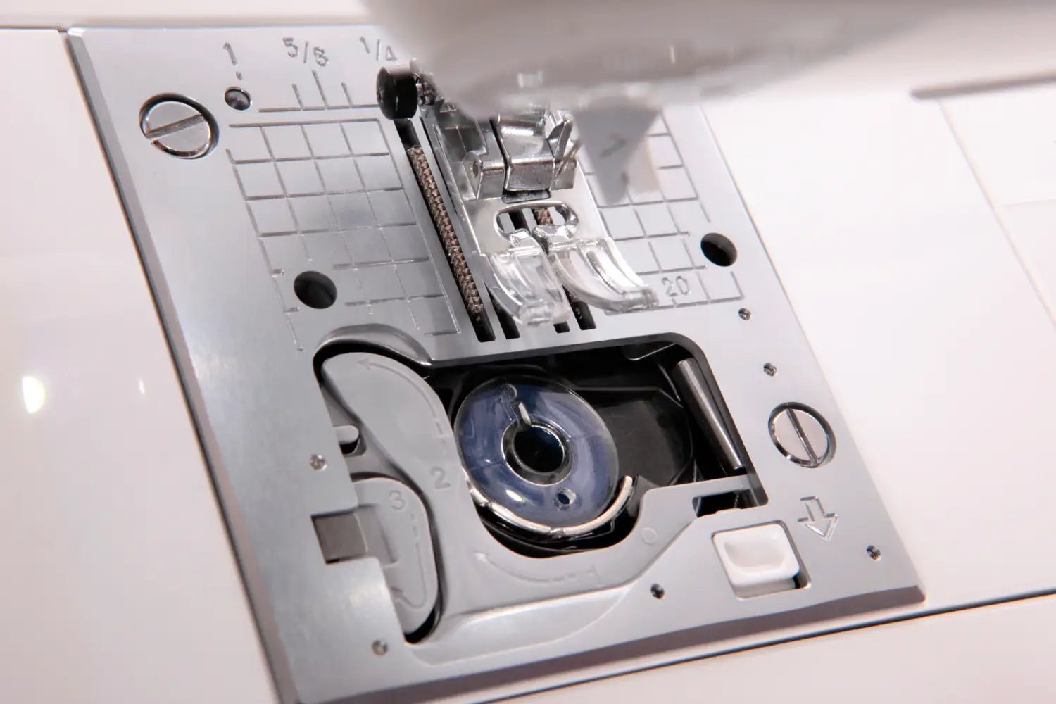 Close-up of a Jukis Exceed -HZL-F300 needle plate with various components.