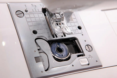 Close-up of a Jukis Exceed -HZL-F300 needle plate with various components.