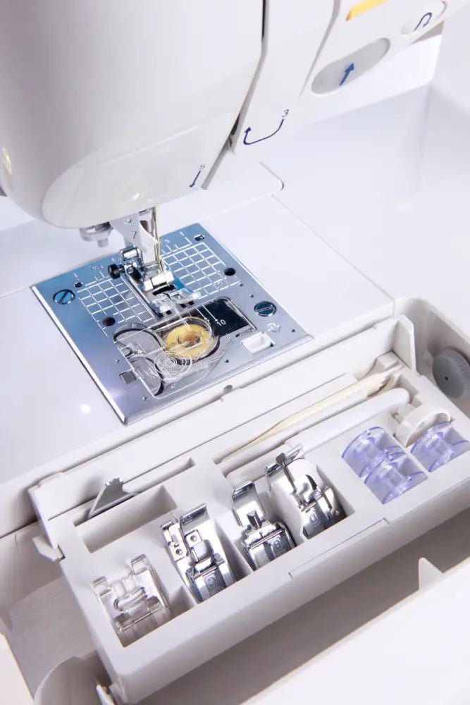 Close-up of a Juki Exceed HZL-F400 with various attachments on a white background