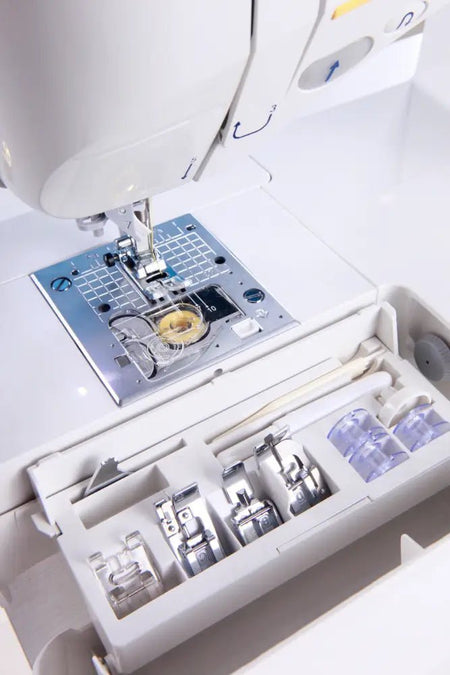 Close-up of a Juki Exceed HZL-F400 with various attachments on a white background