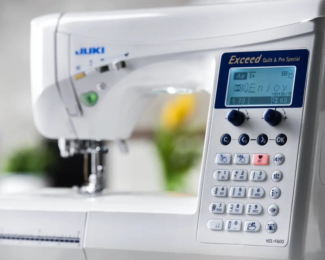 Close-up of a Juki Exceed Quilt & Pro Special HZL-F600 with digital display and control panel.
