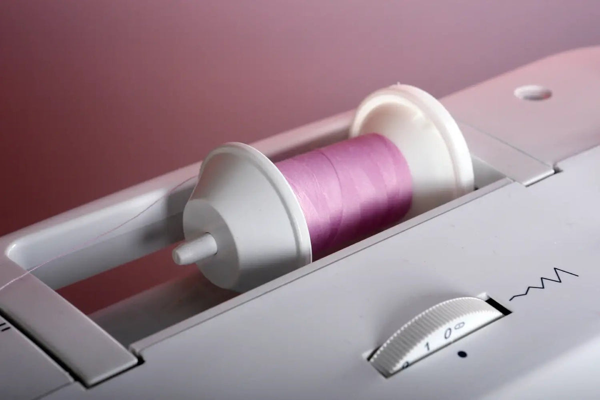 Spool of pink thread in a Juki HZL-353ZR-C Home Sewing Machine