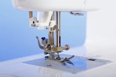 Close-up of a juki HZL-355ZW-A needle plate and presser foot 