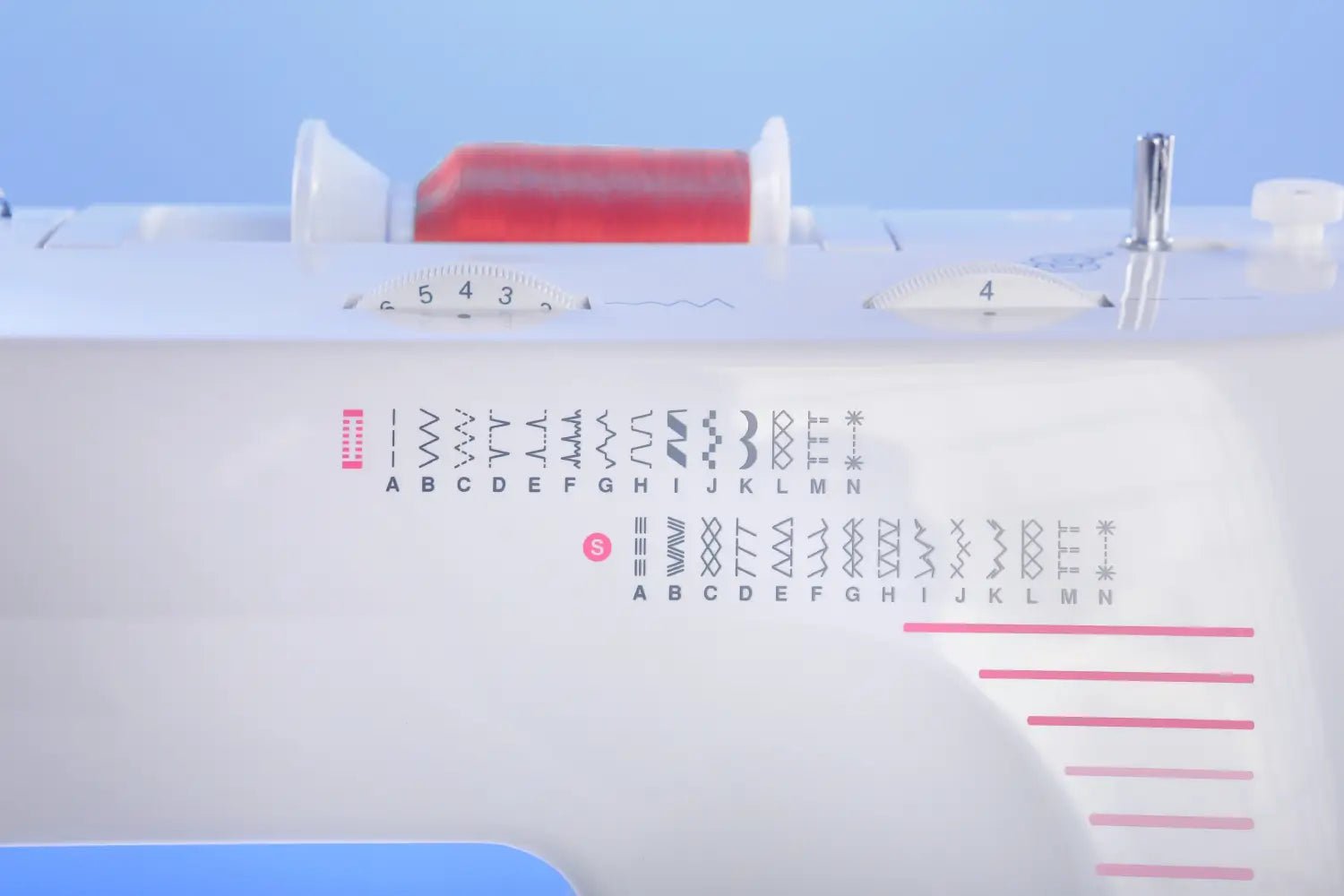 close up of thread spool and stitch patterns on a Juki HZL-355ZW-A