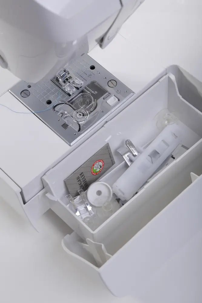 Close-up of a Juki HZL-G120 needle plate and presser foot with storage