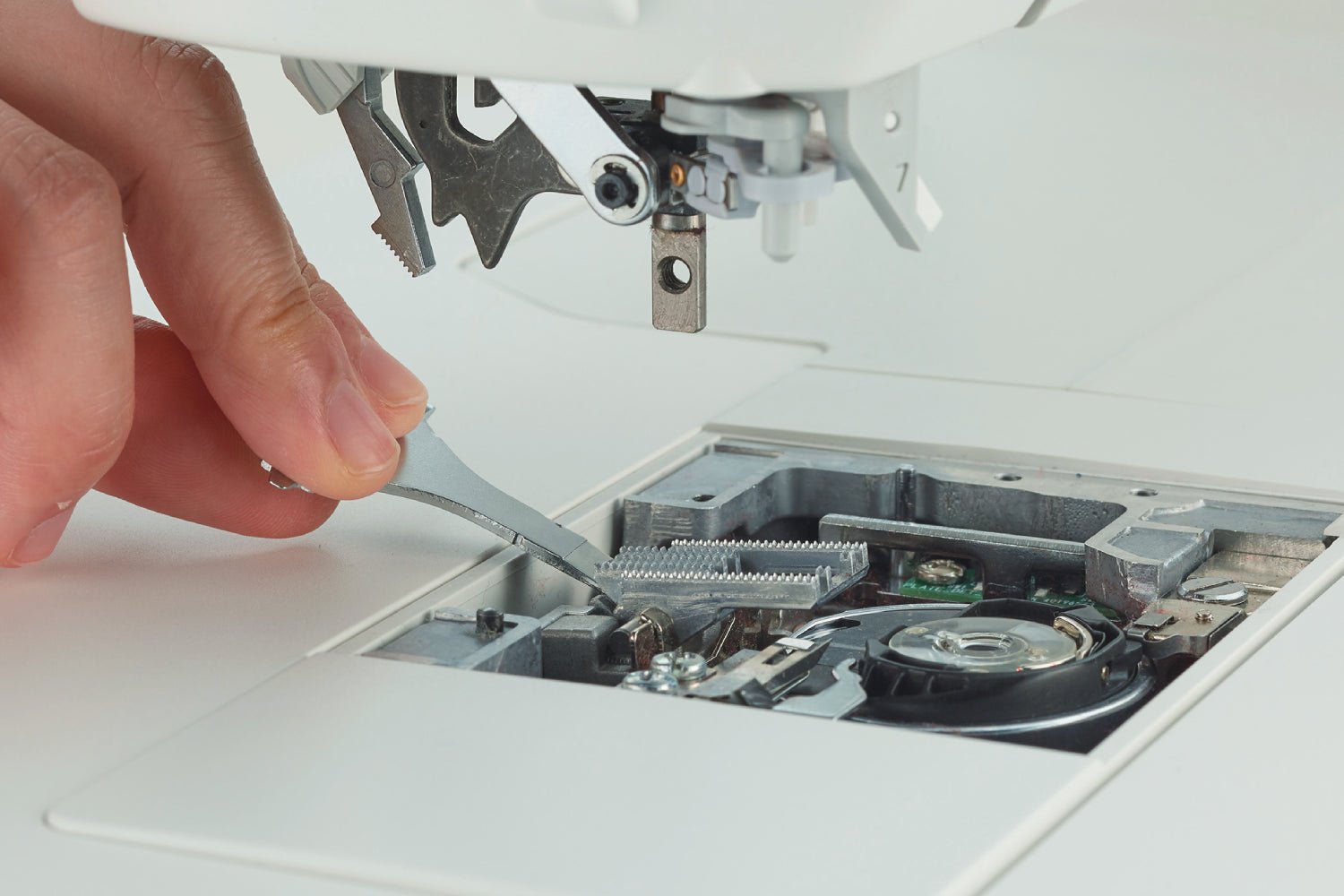 close-up of Juki HZL-NX7 Kirei straight stitch feed dog