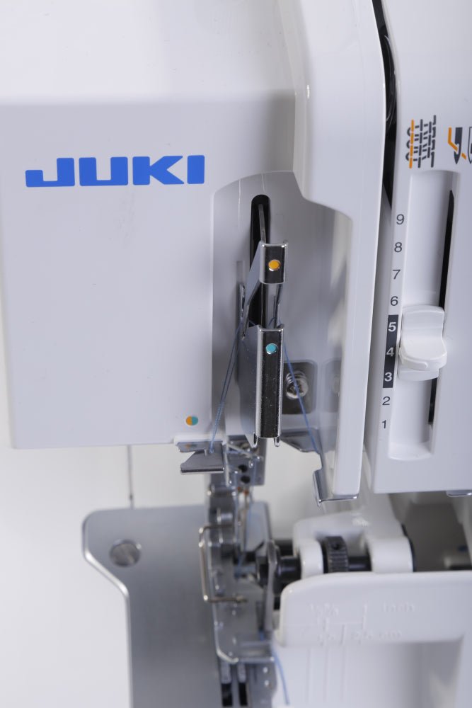 Close-up of a Juki MO-114D sewing machine with needle and presser foot