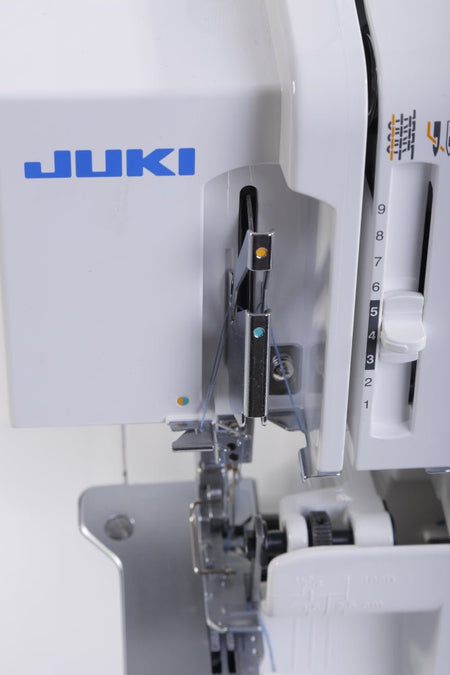 Close-up of a Juki MO-114D sewing machine with needle and presser foot