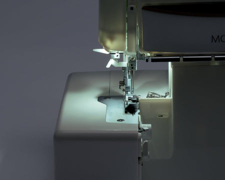 Close-up of a Juki MO-1000 sewing machine with the light on