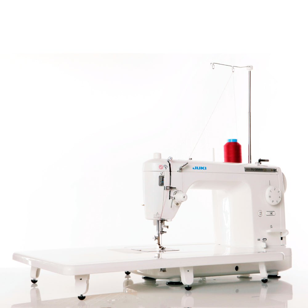 Juki home sewing machine with a red spool on a white background