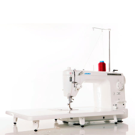 Juki home sewing machine with a red spool on a white background