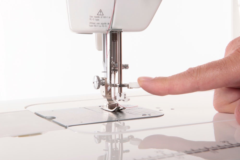 TL-2000Qi Close-up of a sewing machine needle being adjusted