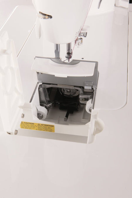 Close-up of a Juki TL-2000Qi sewing machine with a focus on the needle and mechanism.