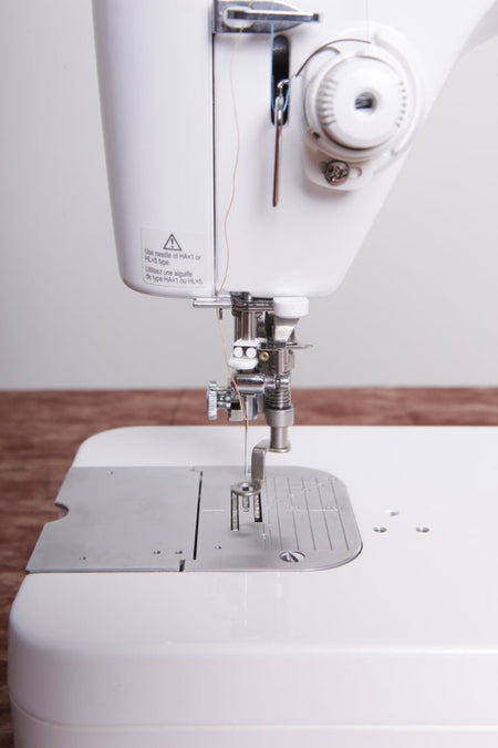 Close-up of a TL-2010Q sewing machine with focus on neddle plate